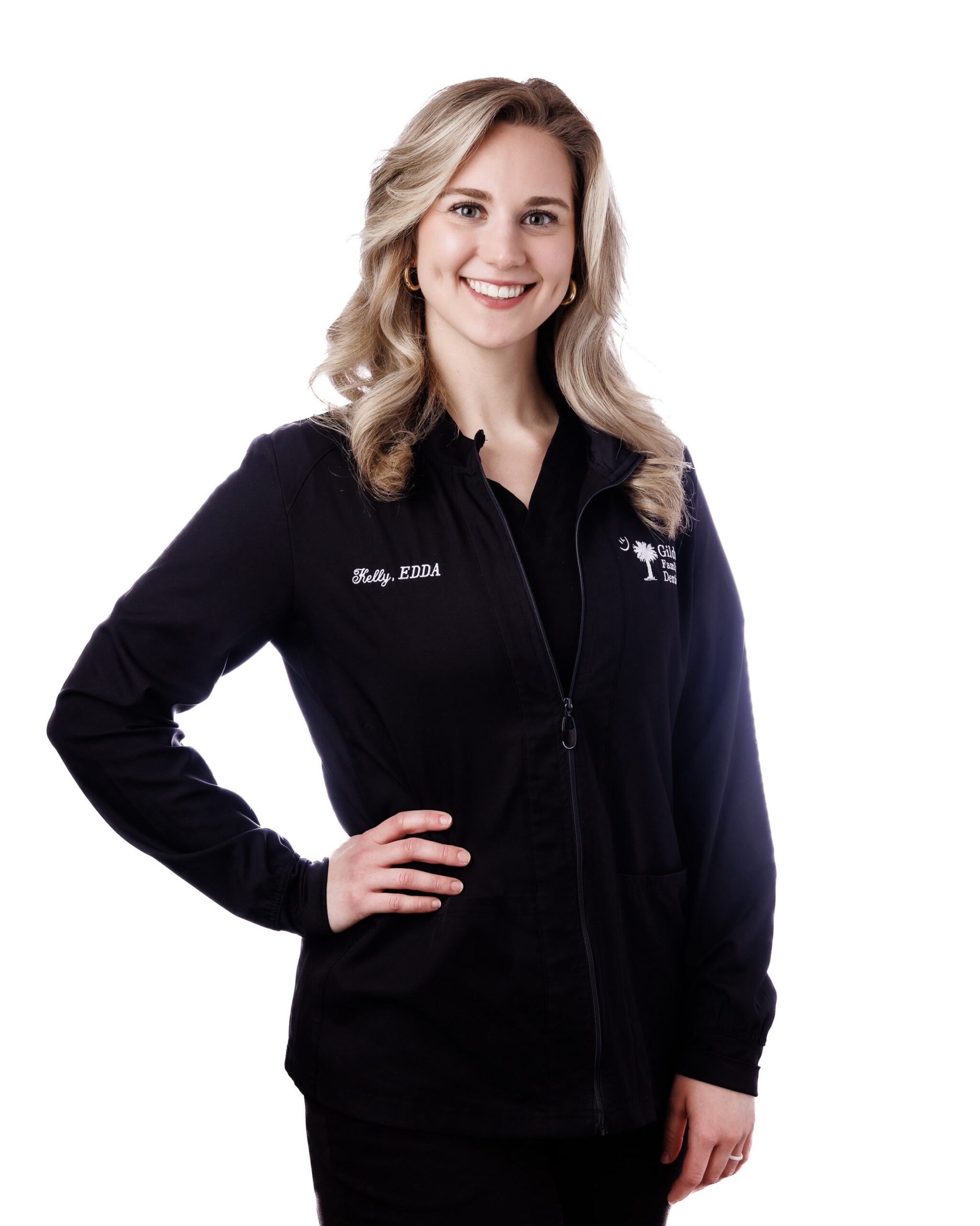 Kelly Rominger, Lead Expanded Duty Dental Assistant and Director of Marketing, wearing a black smock in the doorway at Gildner Family Dentistry in Lexington, SC