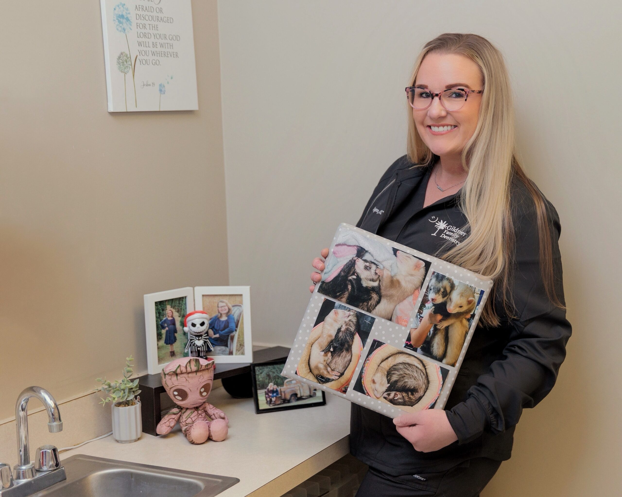 Carynn posing with photos of pets