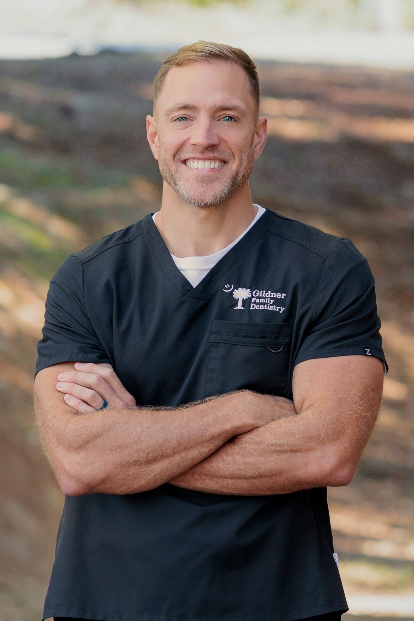 Dr. Robert Gildner wearing a black smock with his arms crossed at Gildner Family Dentistry in Lexington, SC