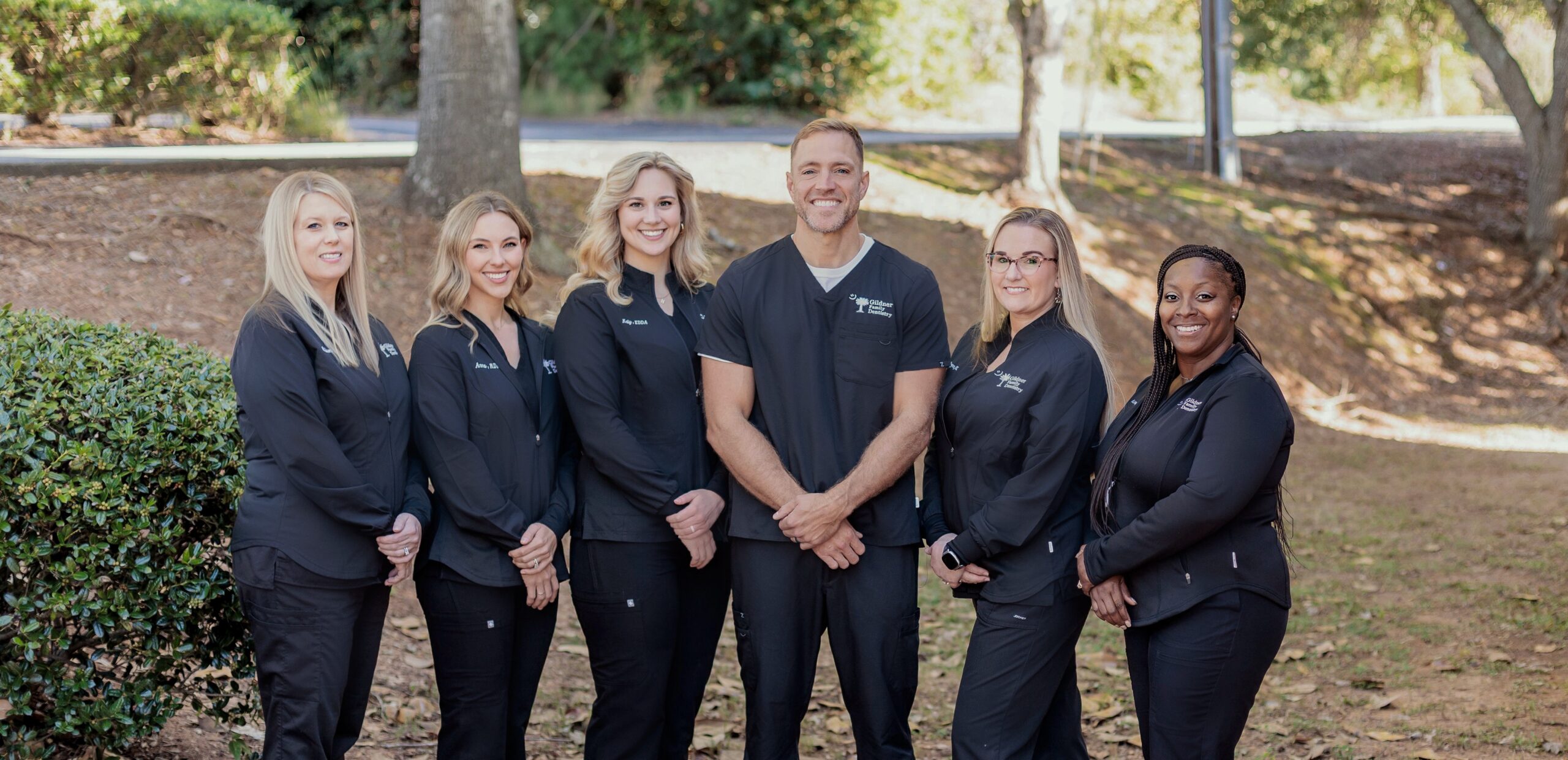 The dental team of Gildner Family Dentistry sitting together and laughing at Gildner Family Dentistry in Lexington, SC