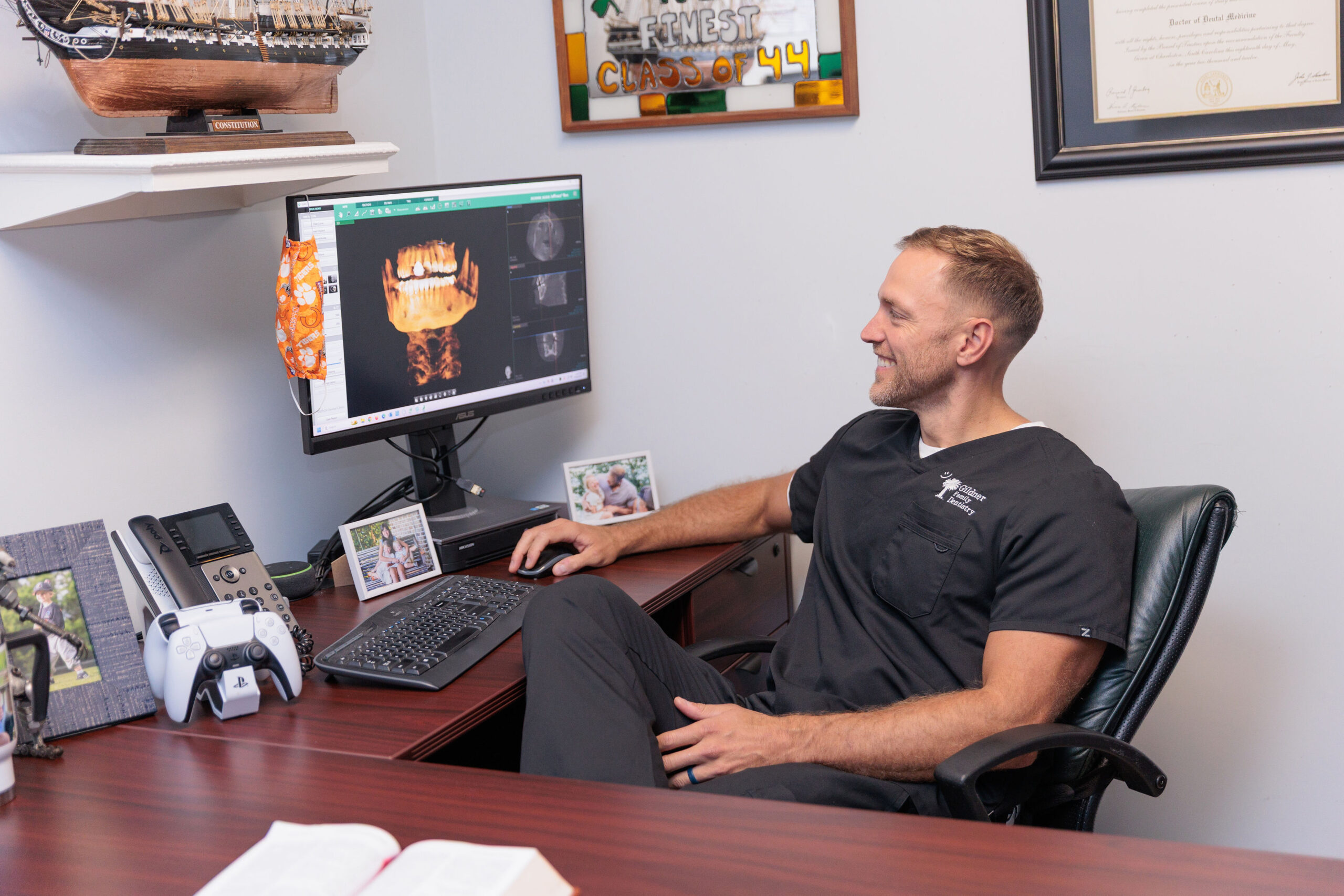 A dental assistant at Gildner Family Dentistry in Lexington, SC using an x-ray machine to take X-rays of a patients mouth
