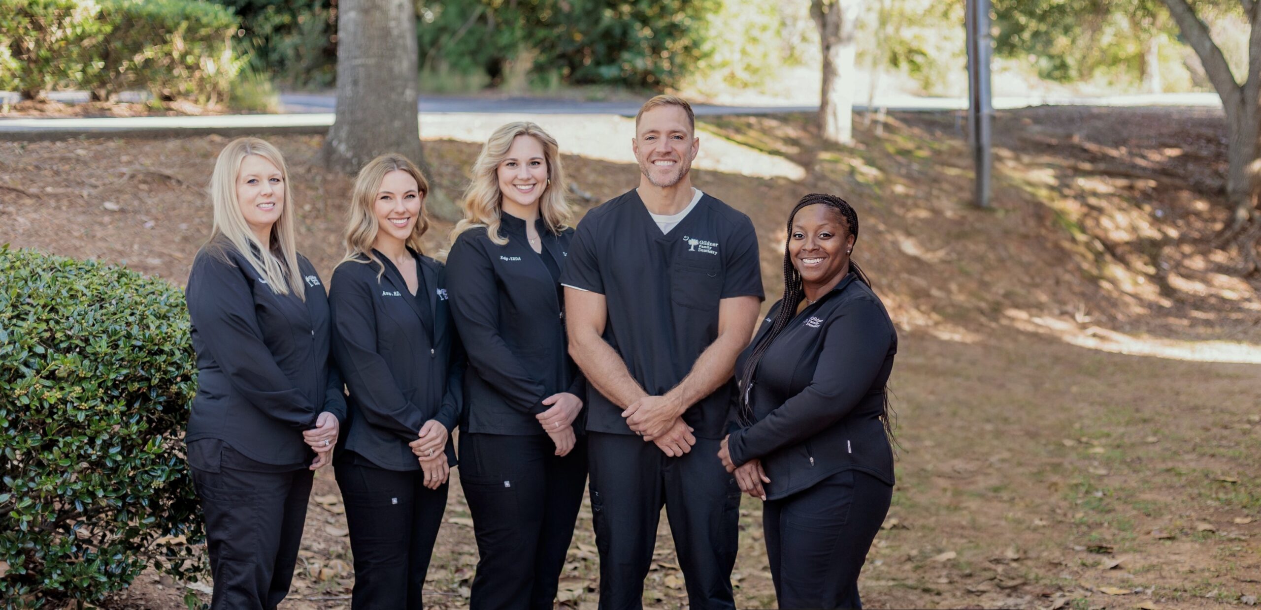 The dental team of Gildner Family Dentistry sitting together and laughing at Gildner Family Dentistry in Lexington, SC